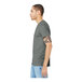 A man wearing a Bella + Canvas deep heather short sleeve t-shirt in grey.