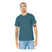 A man wearing a Bella + Canvas heather slate blue t-shirt and jeans.