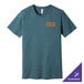 A heather slate Bella Canvas t-shirt with orange letters that read "t-shirt" in a logo.