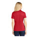 A woman wearing a red Sport-Tek polo shirt with a collar.