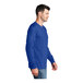 A man wearing a Port & Company royal blue long sleeve T-shirt.