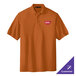A Texas orange Port Authority polo shirt with a logo on it.