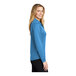 A close-up of a Port Authority Carolina blue long sleeve women's polo shirt.