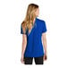 A woman wearing a blue Nike polo shirt.
