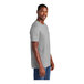 A man wearing a light heather grey District T-shirt.