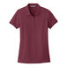 A Port Authority burgundy short sleeve polo shirt for women.