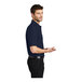A man wearing a navy Port Authority® silk touch pique polo shirt.