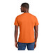 A man wearing a medium orange District T-shirt.