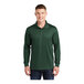 A man wearing a forest green Sport-Tek long sleeve polo shirt.