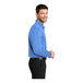 A man wearing a Carolina blue Port Authority® long sleeve polo shirt.