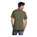 A man wearing a Port & Company olive drab green short sleeve t-shirt.