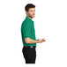 A man wearing a Port Authority Kelly Green Silk Touch Pique Polo Shirt.