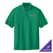 A Kelly green Port Authority polo shirt with an orange logo.