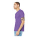 A man wearing a Bella + Canvas heather team purple short sleeve t-shirt.