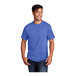 A man wearing a Port & Company heather royal blue short sleeve shirt.