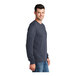 A man wearing a Port & Company long sleeved t-shirt in heather navy.