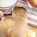 A person pouring Wholesome Natural Turbinado Sugar into a bowl.