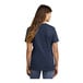 A woman wearing a navy blue Port & Company short sleeve t-shirt.