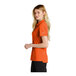 A woman wearing a Nike orange polo shirt.