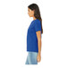 A woman wearing a Bella + Canvas heather true royal short sleeve t-shirt.