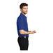 A man wearing a Port Authority® royal blue silk touch polo shirt.