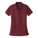 A Port Authority women's maroon polo shirt.