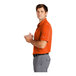A man in a Nike dri-fit orange polo shirt.