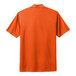 A Nike orange polo shirt with a white collar.