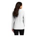 A back view of a white Port Authority women's long sleeve polo shirt.