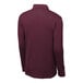 A medium unisex maroon Sport-Tek long sleeve polo shirt on a mannequin.