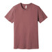 An extra small Bella + Canvas heather mauve short sleeve t-shirt with a small logo on the front.