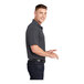 A man in a grey Sport-Tek polo shirt.