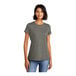 A woman wearing a soft grey District t-shirt.