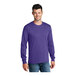 A man wearing a purple Port & Company long sleeve t-shirt.