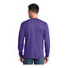 A man wearing a purple Port & Company long sleeve t-shirt.