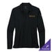 A black Nike women's long sleeve polo shirt on a counter.