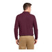 A man wearing a burgundy Port Authority® long sleeve polo shirt.