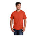 An orange Port & Company short sleeve T-shirt on a smiling man.