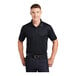 A man wearing a black Sport-Tek short sleeve polo shirt.