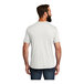 A man wearing a white AllMade short sleeve T-shirt.