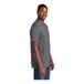 A man wearing a heathered charcoal District T-shirt smiling.
