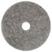 A grey circular Scrubble heavy burnishing floor pad with a hole in the center.