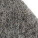 A close-up of a white and gray Scrubble heavy burnishing floor pad.
