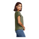 A woman wearing an olive green AllMade tri-blend short sleeve tee.