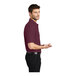 A man in a maroon Port Authority silk touch polo shirt.