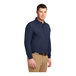 A man wearing a Port Authority navy blue long sleeve polo shirt.
