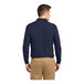 A man wearing a Port Authority navy long sleeve polo shirt.