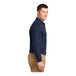 A man wearing a Port Authority navy blue long sleeve polo shirt.
