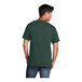 A man wearing a dark green Port & Company short sleeve t-shirt.