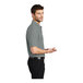 A man wearing a Port Authority Cool Gray Silk Touch Pique Polo shirt.
